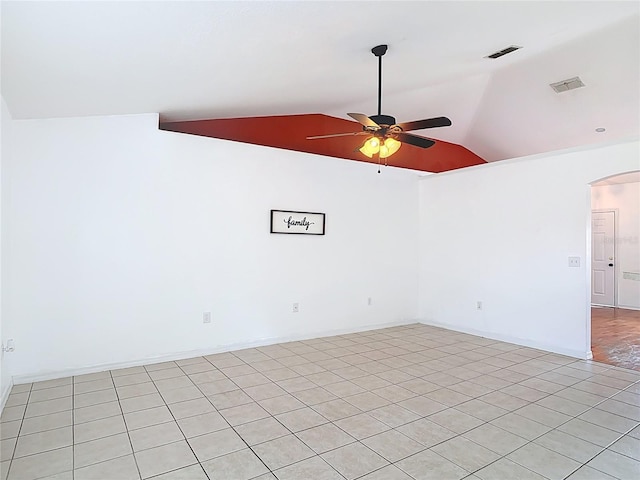 empty room featuring visible vents, a ceiling fan, arched walkways, and vaulted ceiling