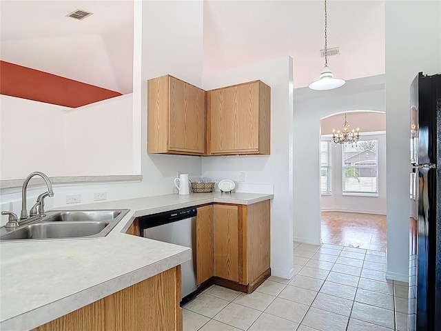 kitchen with visible vents, stainless steel dishwasher, a sink, freestanding refrigerator, and an inviting chandelier