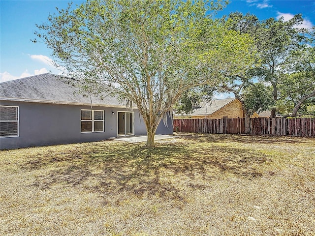 view of yard featuring fence and a patio area