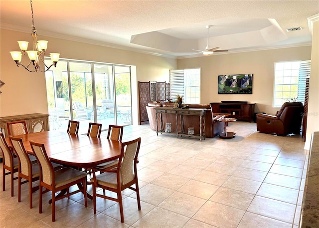 871 Iron Oak Way, The Villages, FL 32163 - dining area with ceiling fan with notable chandelier, light tile patterned floors, crown molding, and a tray ceiling