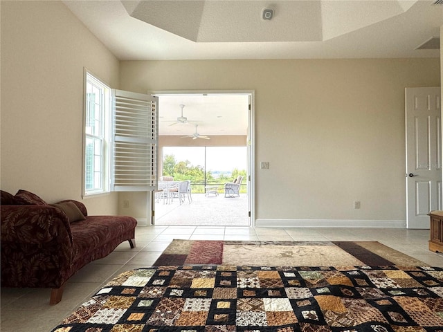 871 Iron Oak Way, The Villages, FL 32163 - interior space featuring baseboards, a ceiling fan, a raised ceiling, and light tile patterned floors