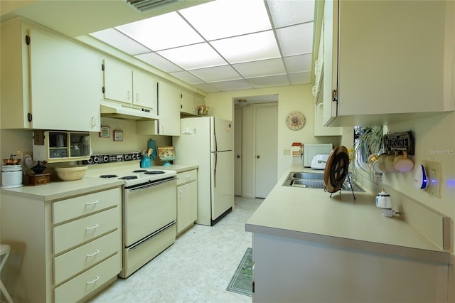 9 Buck Cir Unit 9, Haines City, FL 33844 - kitchen featuring white appliances, light countertops, a paneled ceiling, light floors, and under cabinet range hood