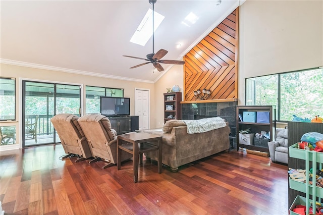 living room with crown molding, wood finished floors, and a healthy amount of sunlight