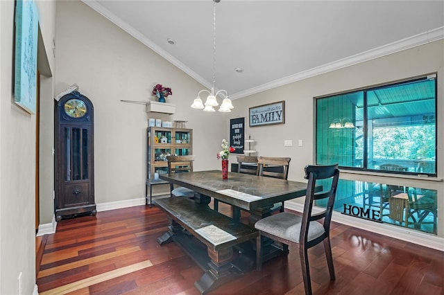 dining space with a chandelier, ornamental molding, wood finished floors, and lofted ceiling
