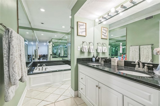 bathroom with a sink, tile patterned flooring, a garden tub, and visible vents