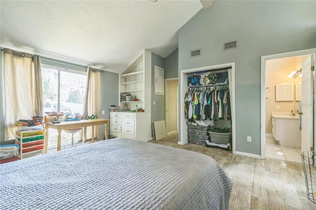 bedroom with baseboards, visible vents, light wood-type flooring, and a closet