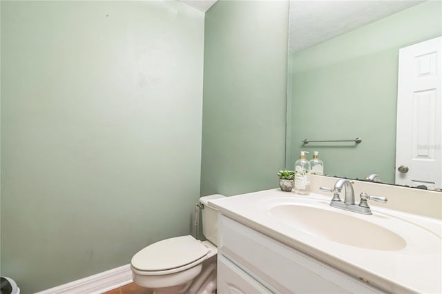 half bathroom with toilet and vanity