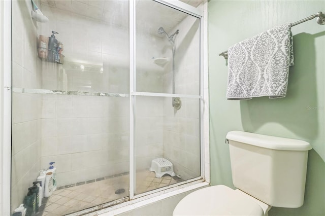 full bath with toilet and a shower stall