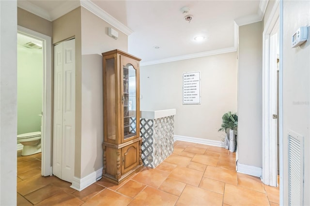 hall with baseboards, visible vents, ornamental molding, and light tile patterned floors