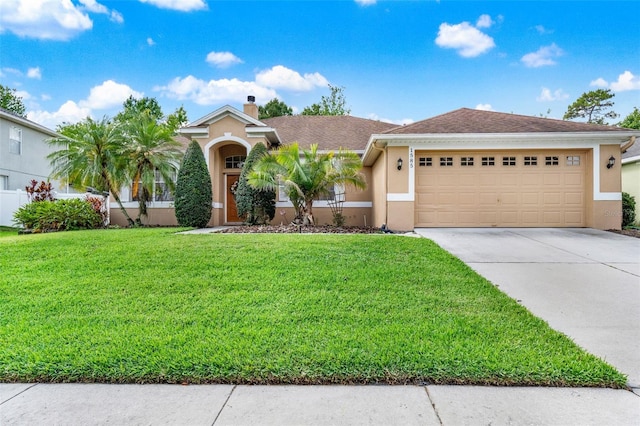 view of front of property with stucco siding, driveway, a front yard, a garage, and a chimney