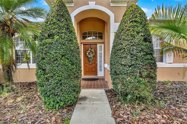 property entrance with stucco siding
