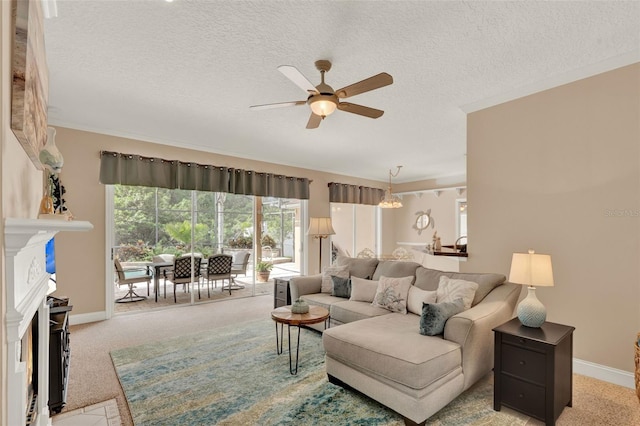 carpeted living room featuring a ceiling fan, a textured ceiling, a fireplace, and baseboards