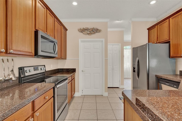 kitchen featuring appliances with stainless steel finishes, ornamental molding, light tile patterned floors, brown cabinetry, and recessed lighting