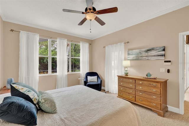 bedroom featuring crown molding, carpet flooring, baseboards, and ceiling fan