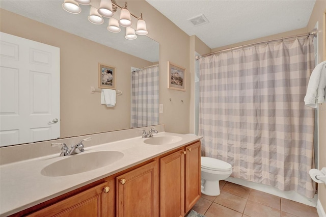 bathroom with toilet, tile patterned flooring, double vanity, and a shower with curtain