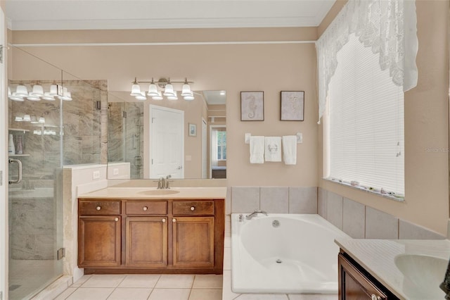 full bath with two vanities, a stall shower, tile patterned floors, a garden tub, and ornamental molding