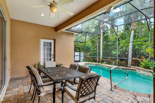 swimming pool featuring a patio, a ceiling fan, a lanai, and outdoor dining space