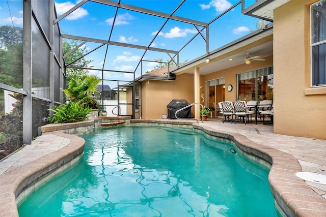 view of pool with a patio area, area for grilling, ceiling fan, a pool with connected hot tub, and a lanai