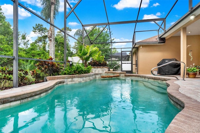 view of pool with glass enclosure, a patio, and a pool with connected hot tub