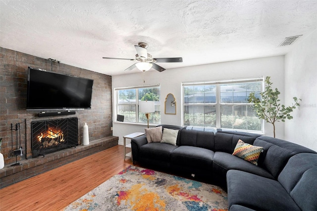 6801 16th St N, Saint Petersburg, FL 33702 - living area with a ceiling fan, visible vents, a textured ceiling, and wood finished floors