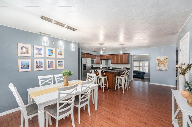 6801 16th St N, Saint Petersburg, FL 33702 - dining area with baseboards, light wood-style floors, and visible vents