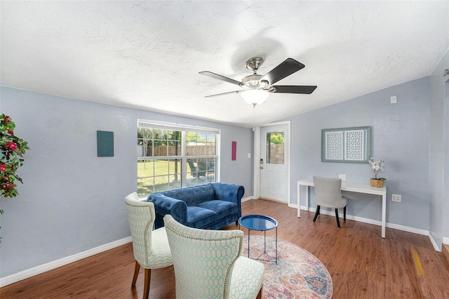 6801 16th St N, Saint Petersburg, FL 33702 - living room with a ceiling fan, vaulted ceiling, a textured ceiling, and wood finished floors