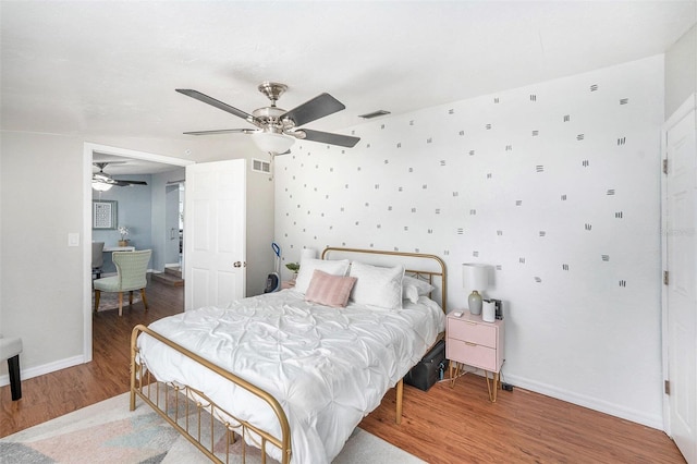 6801 16th St N, Saint Petersburg, FL 33702 - bedroom with a ceiling fan, visible vents, wood finished floors, and baseboards