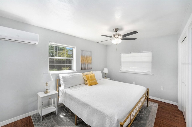 6801 16th St N, Saint Petersburg, FL 33702 - bedroom featuring baseboards, ceiling fan, a wall unit AC, and wood finished floors