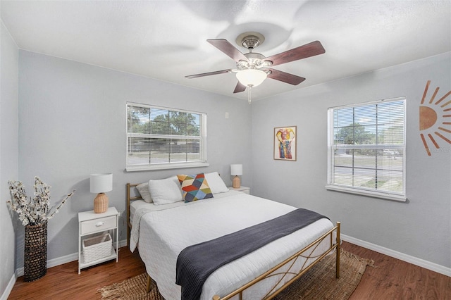 6801 16th St N, Saint Petersburg, FL 33702 - bedroom featuring multiple windows, a ceiling fan, wood finished floors, and baseboards