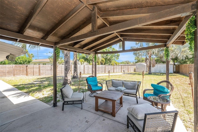 6801 16th St N, Saint Petersburg, FL 33702 - view of patio / terrace featuring a storage shed, an outdoor hangout area, an outdoor structure, and a fenced backyard