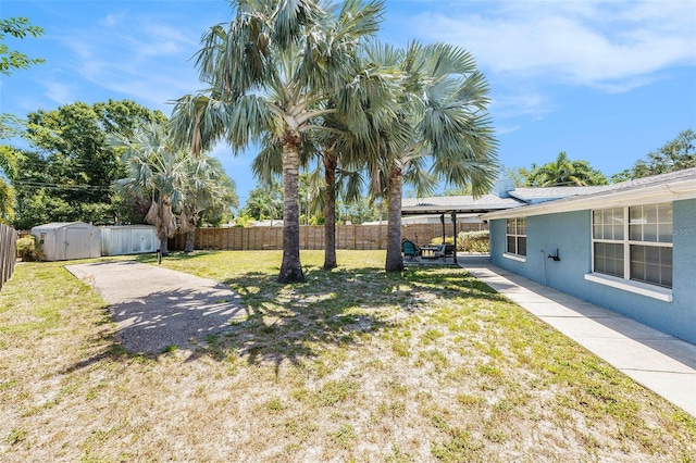 6801 16th St N, Saint Petersburg, FL 33702 - view of yard with a fenced backyard, a storage shed, a patio, and an outbuilding