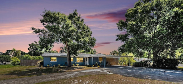 6801 16th St N, Saint Petersburg, FL 33702 - ranch-style home featuring an attached carport, aphalt driveway, and fence
