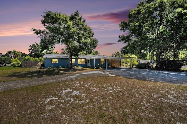 6801 16th St N, Saint Petersburg, FL 33702 - view of front facade with an attached carport, fence, and aphalt driveway
