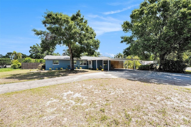 6801 16th St N, Saint Petersburg, FL 33702 - ranch-style house featuring a front lawn, driveway, fence, and an attached carport