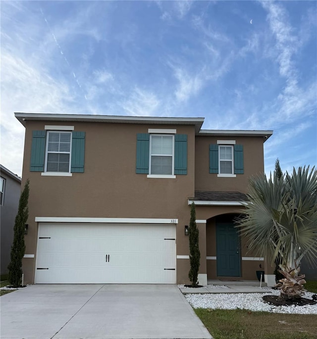 321 Jovana Rd, Davenport, FL 33837 - traditional home featuring driveway, stucco siding, and a garage