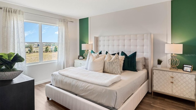 bedroom featuring dark wood-type flooring and baseboards