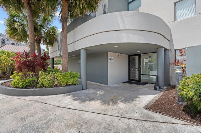 property entrance with stucco siding