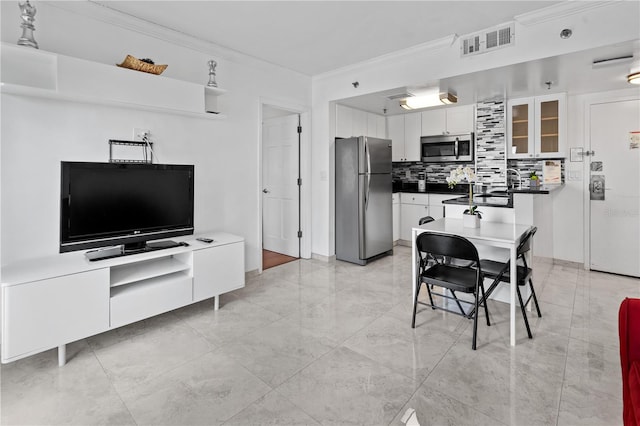 dining area with visible vents, ornamental molding, and marble finish floor