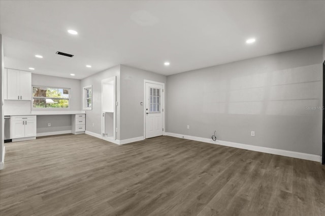 2014 10th St NW, Winter Haven, FL 33881 - unfurnished living room with baseboards, recessed lighting, wood finished floors, and visible vents