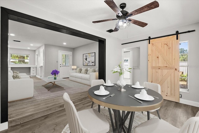 2014 10th St NW, Winter Haven, FL 33881 - dining room with a ceiling fan, a barn door, wood finished floors, baseboards, and recessed lighting