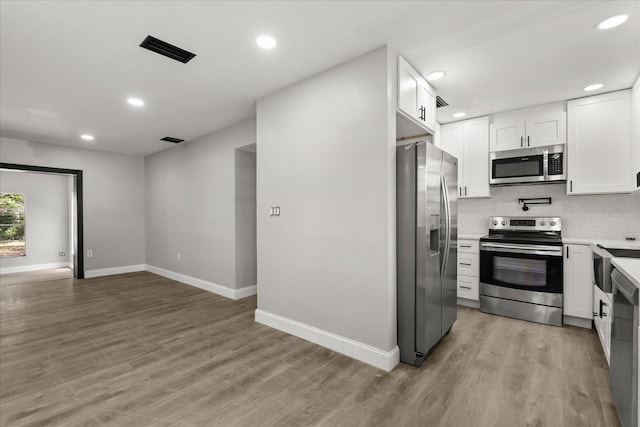 2014 10th St NW, Winter Haven, FL 33881 - kitchen featuring appliances with stainless steel finishes, recessed lighting, and light wood-style flooring