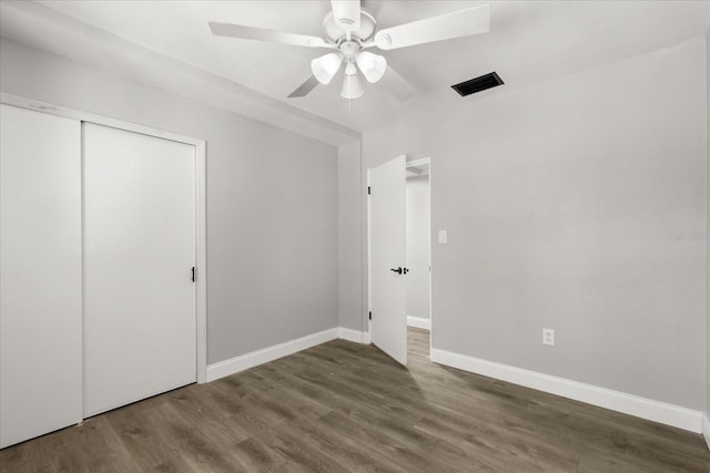 2014 10th St NW, Winter Haven, FL 33881 - unfurnished bedroom featuring ceiling fan, baseboards, wood finished floors, visible vents, and a closet