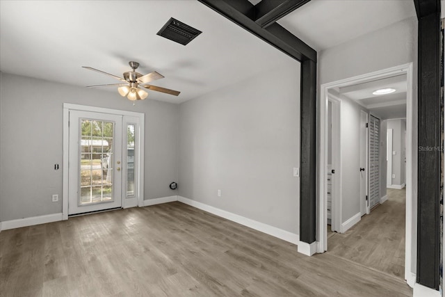 2014 10th St NW, Winter Haven, FL 33881 - unfurnished room with light wood-style floors, a ceiling fan, baseboards, and visible vents