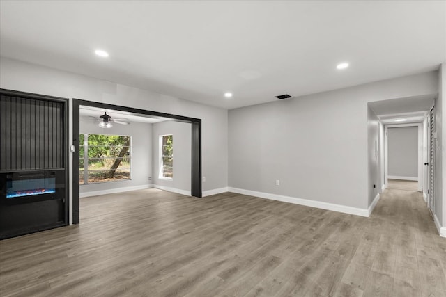 2014 10th St NW, Winter Haven, FL 33881 - unfurnished living room with baseboards, recessed lighting, and wood finished floors