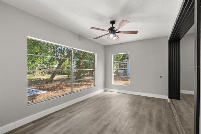 2014 10th St NW, Winter Haven, FL 33881 - unfurnished room featuring baseboards, ceiling fan, and wood finished floors