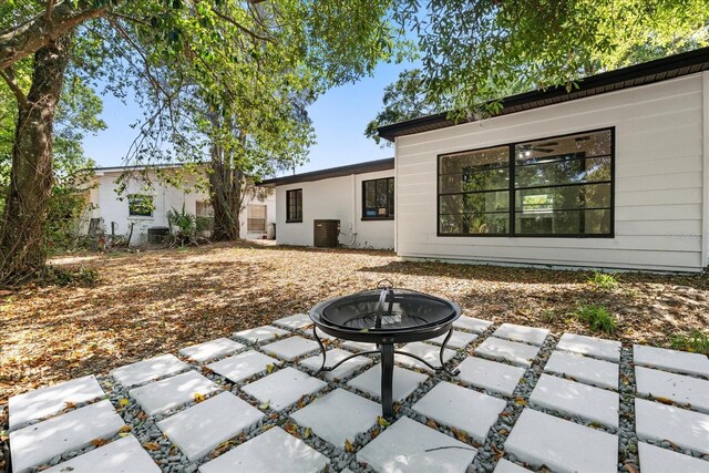 2014 10th St NW, Winter Haven, FL 33881 - view of patio / terrace featuring central AC unit and a fire pit