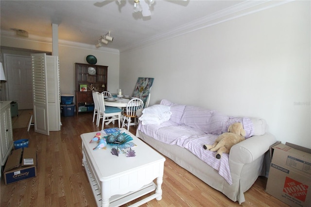 living area featuring ornamental molding, a ceiling fan, and wood finished floors