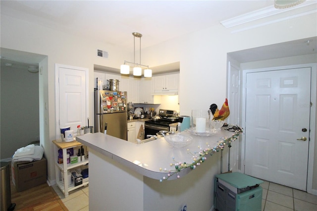 kitchen featuring visible vents, a peninsula, under cabinet range hood, appliances with stainless steel finishes, and light tile patterned floors
