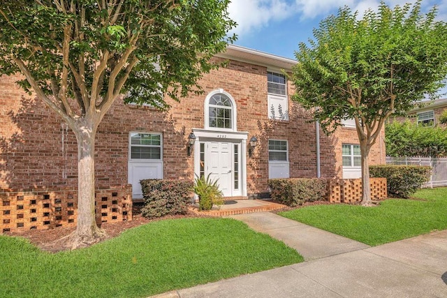 4262 Lake Underhill Rd Unit 9C7, Orlando, FL 32803 - colonial-style house featuring brick siding