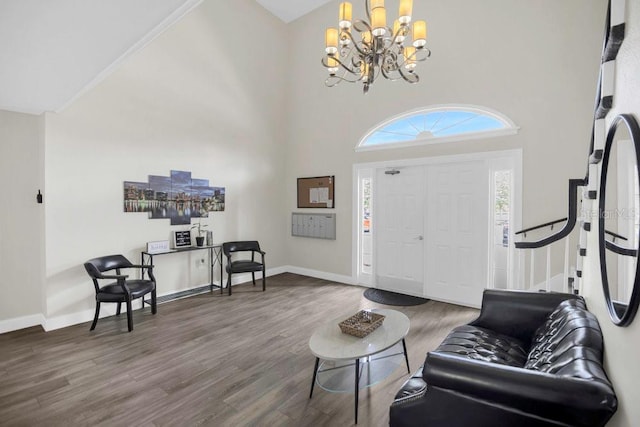 4262 Lake Underhill Rd Unit 9C7, Orlando, FL 32803 - foyer entrance featuring a chandelier, wood finished floors, baseboards, a towering ceiling, and stairway